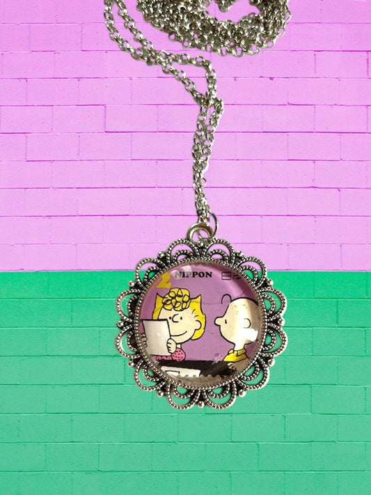 Collana artigianale italiana con francobollo giapponese dei Peanuts, Sally e Linus, cornice argentata traforata