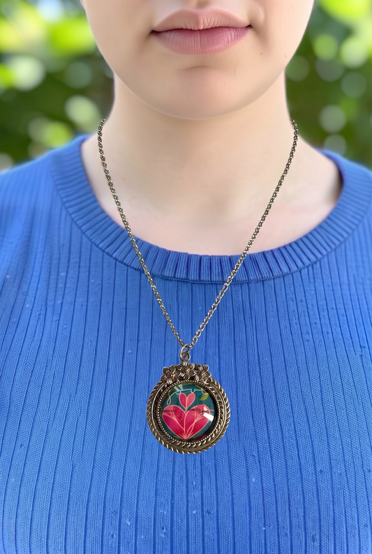Collana artigianale indossata con francobollo americano di un cuore rosa fiorito, cornice argentata a fiori, Italia