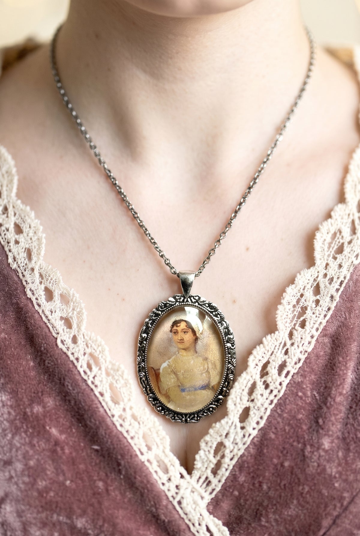 Collana artigianale indossata con ciondolo ovale e ritratto di Jane Austen, argento, Italia
